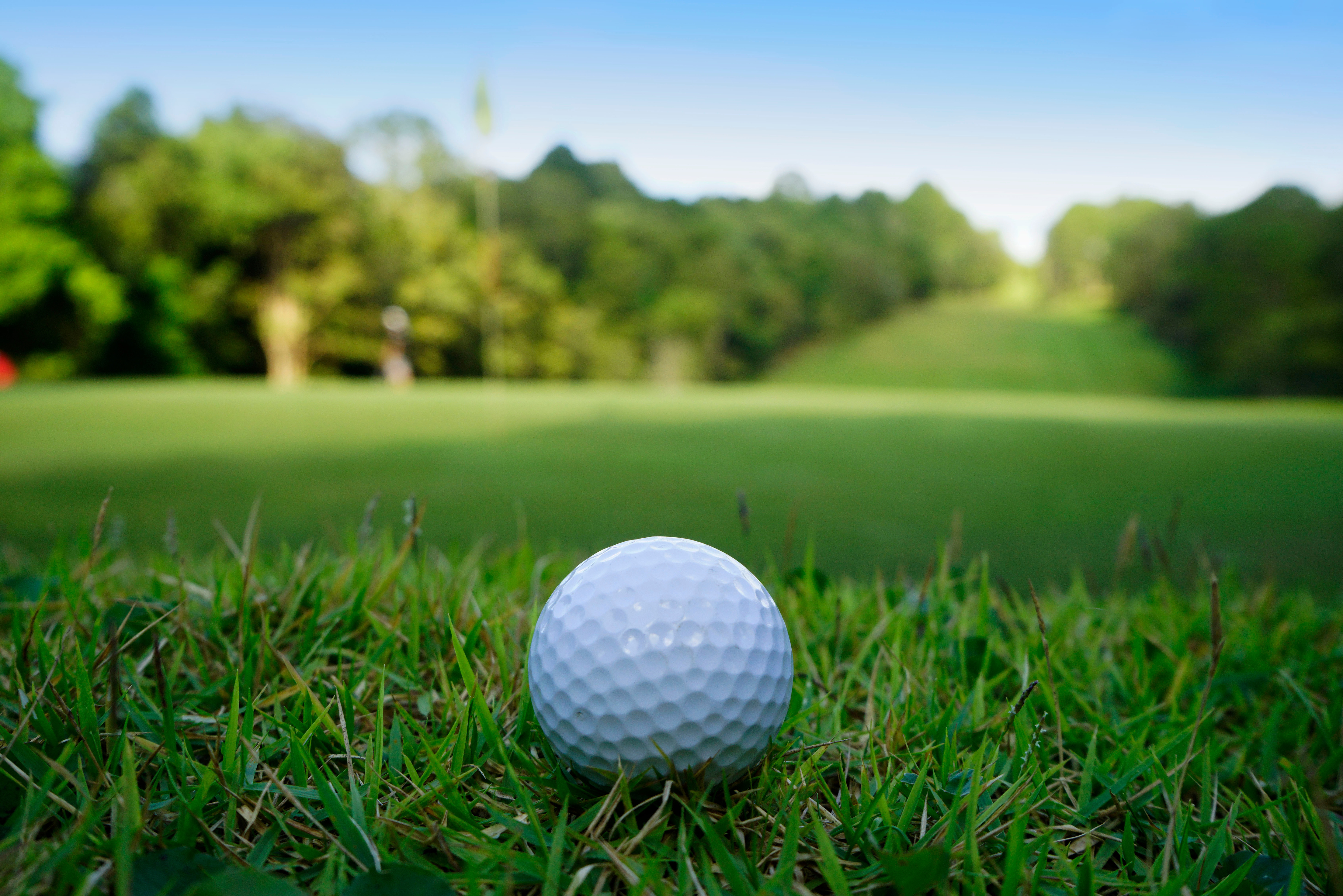 Golf ball on green in beautiful golf course at sunset background. Golf ball on green in golf course at Thailand